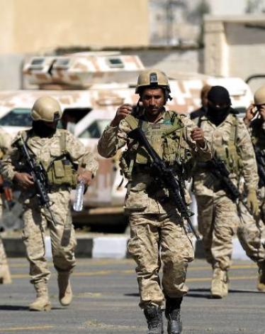 Shiite Huthi fighters walk outside in front of al-Saleh mosque