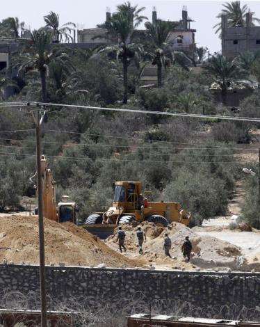 A-view-of-soldiers-from-the-Egyptian-army-destroying-the-infraestructure-of-smuggling-tunnels-along-the-EgyptGaza-border-is-seen-from-Rafah