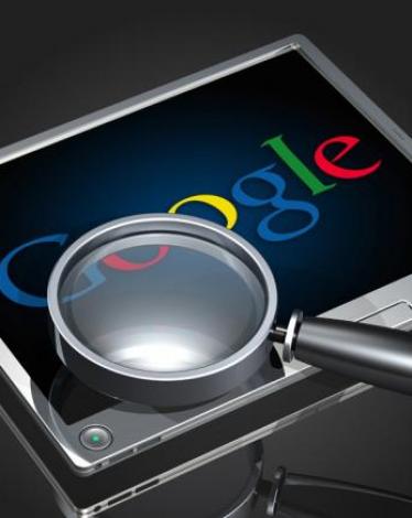 magnifying-glass-hovering-over-google-logo-displayed-on-a-tablet-device