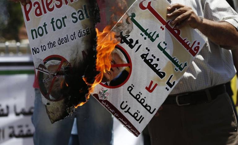77707915_Palestinians-burn-portraits-of-US-President-Donald-Trump-during-a-demonstration-in-the-West