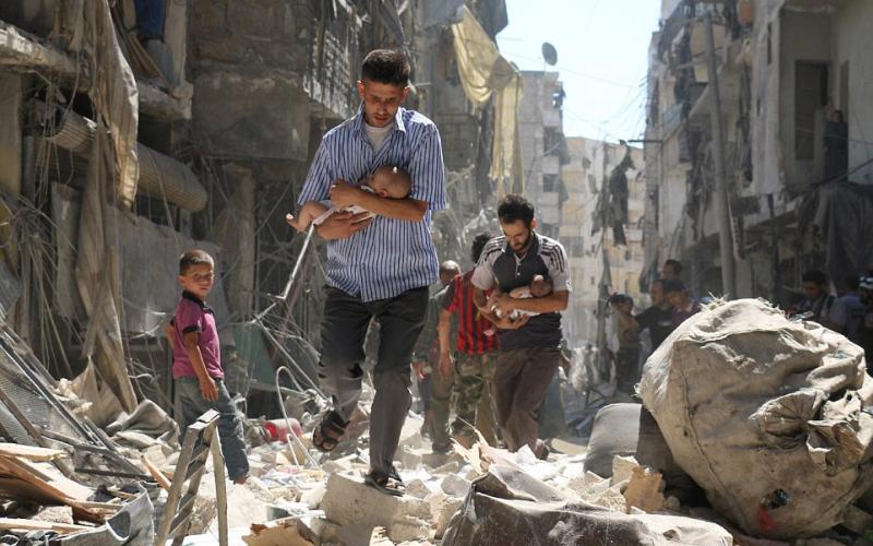 3B563D8E00000578-4029044-Syrian_men_carrying_babies_make_their_way_through_the_rubble_of_-a-21_1481671250436_758669