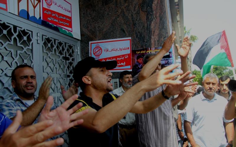 صور: وقفة لأيتام غزة أمام بنك فلسطين