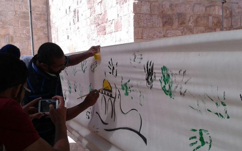 ‫‏صور: رسم جدارية في الأقصى تحوي بصمة الأطفال