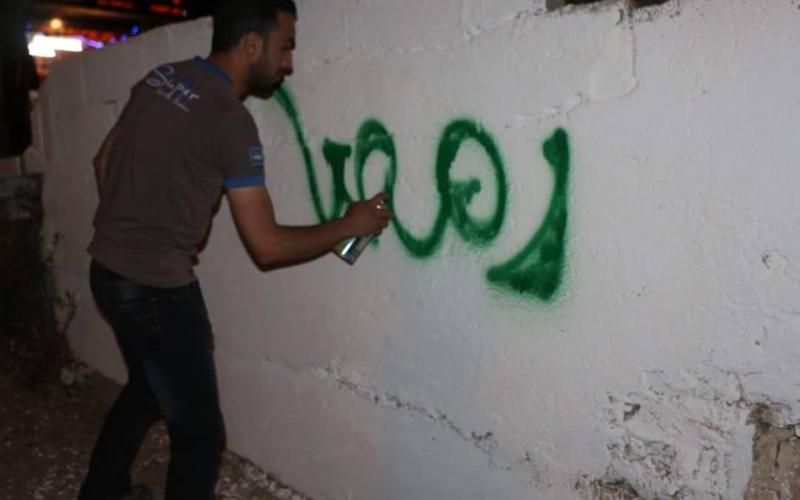 صور: جدران الخليل تتزين بعبارات رمضانية