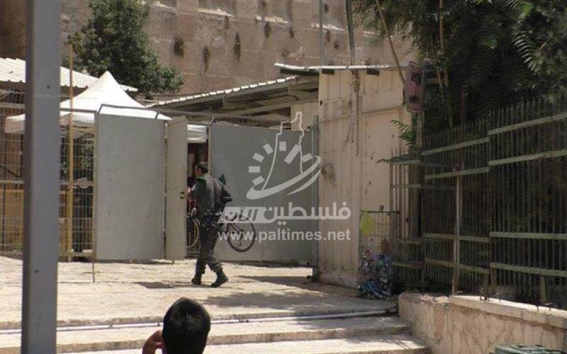 بالصور: جندي يعتدي على طفل ويصادر دراجته في الخليل