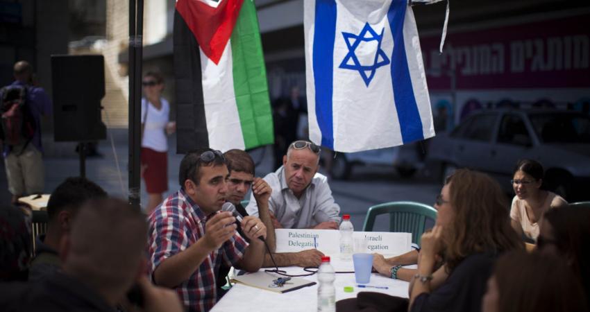 Palestinian-and-Israeli-people-discuss-at-a-public-negotiation-congress