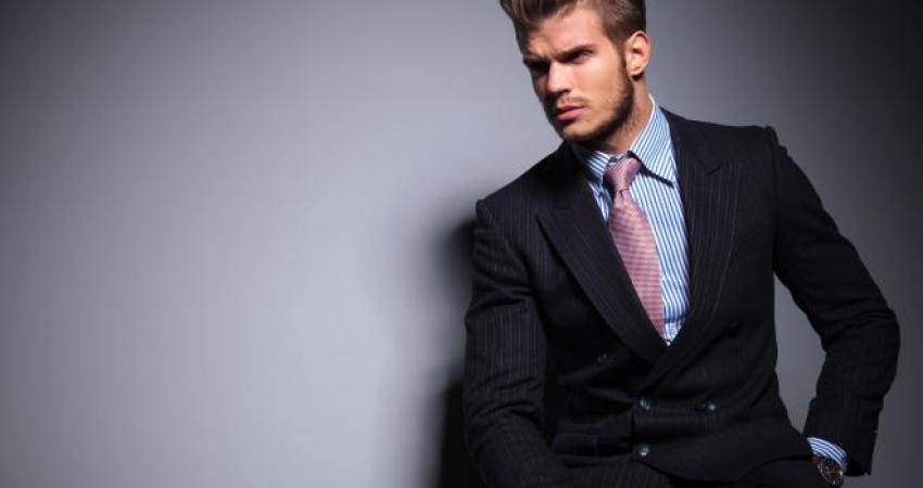 seated-young-fashion-model-in-suit-looks-away