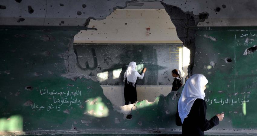 palestine-gaza-school-classroom-shelled-hole-in-the-wall-board
