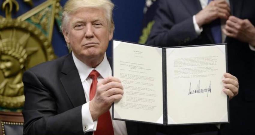 President Donald Trump signs executive orders at the Pentagon on Jan. 27. epa